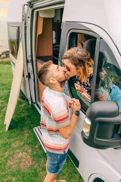 istock Couple kissing through the camper van window during a trip 1385942917