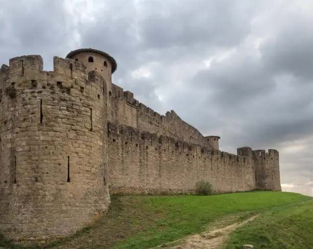 Photo of Ruins of the fortified medieval citadel of Carcassone, Aude, Occitanie, France. An imposing UNESCO World Heritage Site