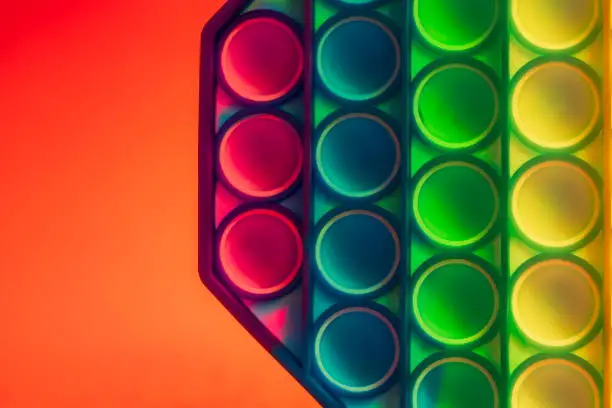 Photo of Close up shot of octagon pop it toy on colorful background. Indoors