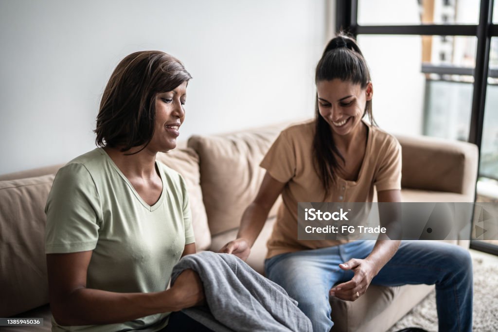 Lesbian couple packing her clothes for a trip (or organizing clothes) at home 35-39 Years Stock Photo