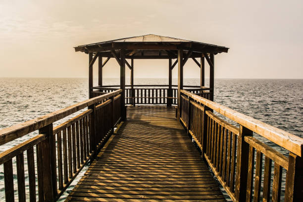 A wooden covered pier on the waterfront of Garda town on the east shore of lake Garda, Verona Province, Veneto, north east Italy