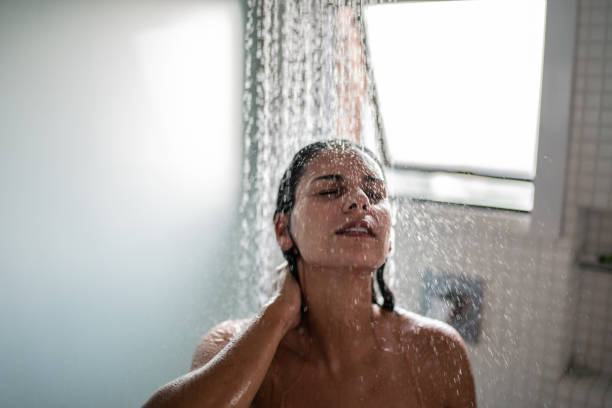woman taking a shower at home - naked people women female imagens e fotografias de stock