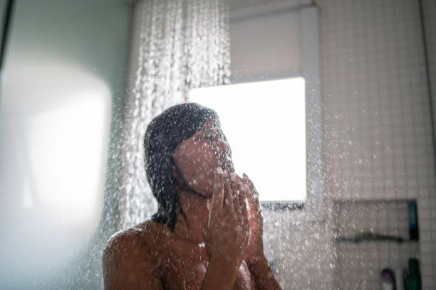 Woman taking a shower at home Woman taking a shower at home black woman washing hair stock pictures, royalty-free photos & images