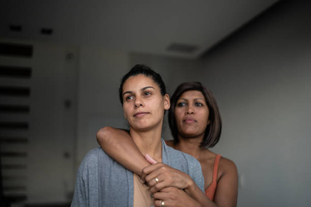 Contemplative lesbian couple at home