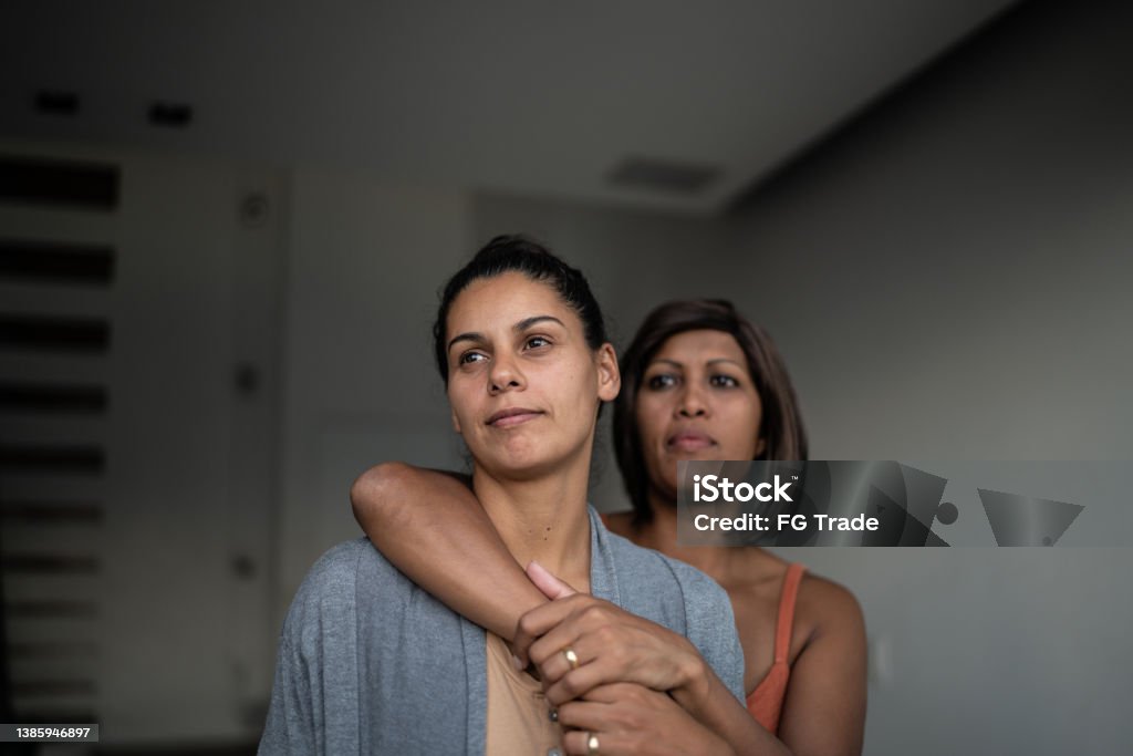 Contemplative lesbian couple at home Couple - Relationship Stock Photo