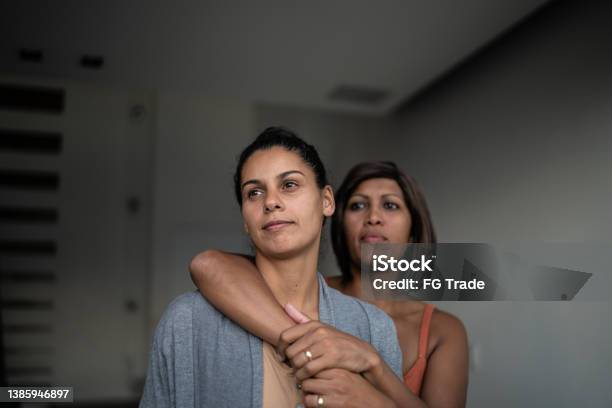 Contemplative Lesbian Couple At Home Stock Photo - Download Image Now - Couple - Relationship, Gay Couple, Contemplation