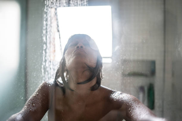 istock Woman taking a shower at home 1385947050