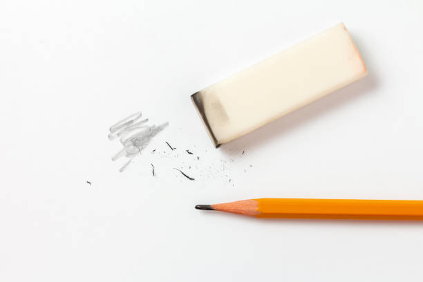 Eraser with traces of dust and a pencil on a white sheet Eraser with traces of dust and graphite and a pencil on a white sheet of paper eraser photos stock pictures, royalty-free photos & images