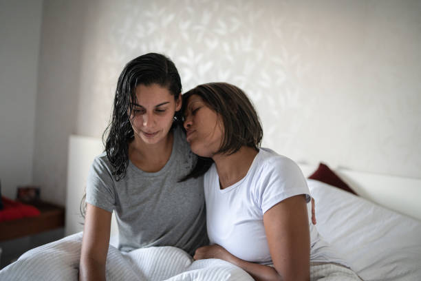 istock Lesbian couple hugging in the bed at home 1385948063