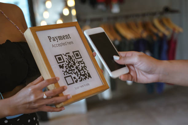 istock Unrecognizable Female Hands Scanning QR Code For Paying Clothes With Contactless Payment 1385949269