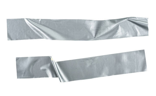 istock Pieces of silver self-adhesive construction tape isolated on a white background, top view. Metallic reinforced tape. 1385949799