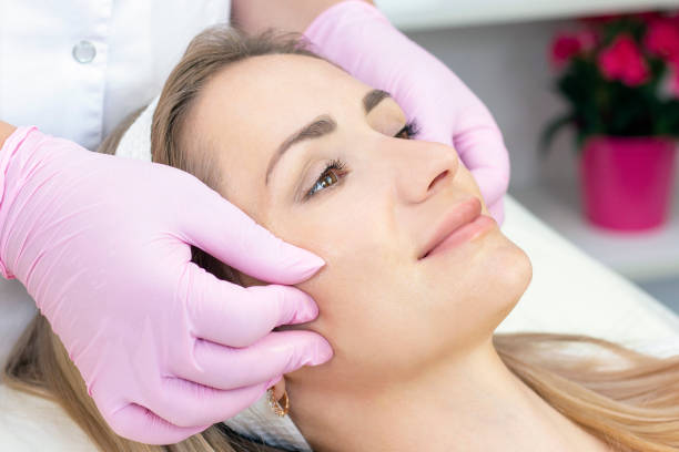 istock Young woman face massage. 1385949897