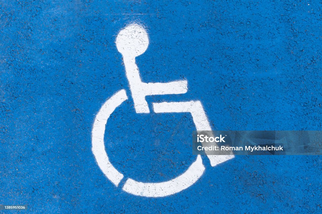Symbol of a disabled parking space painted on asphalt. Accessible Parking Sign Stock Photo