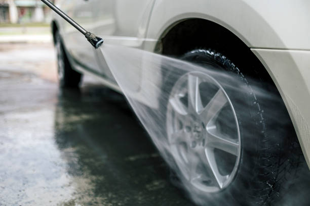 istock Unrecognizable person washes the car with a hose 1385951140