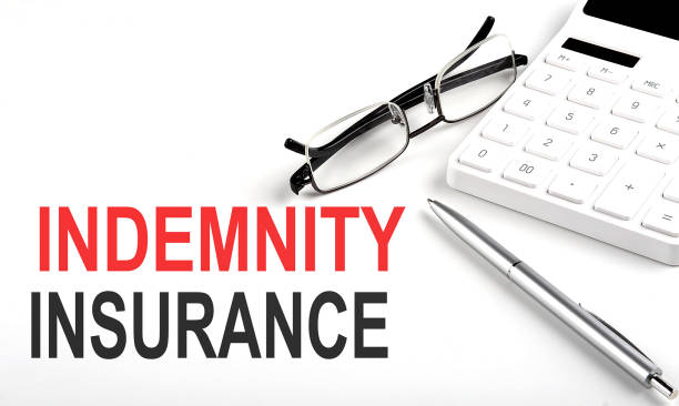 istock INDEMNITY INSURANCE Concept. Calculator,pen and glasses on white background 1385951928