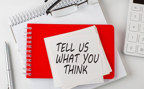 istock TELL US WHAT YOU THINK word on sticker on notepad with pen and calculator 1385951937