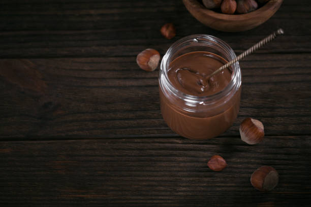 istock Homemade Chocolate Hazelnut Milk Spread on a dark Background 1385955256
