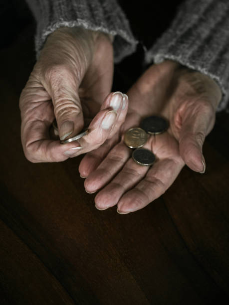 istock Pensioner counting money into her hands 1385955453