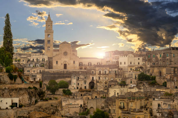 Matera, Basilicata, Italy.August 2021. Matera, Basilicata, Italy. August 2021. The facade of the cathedral at the golden hour. Around the typical houses of the stones of Matera. matera stock pictures, royalty-free photos & images