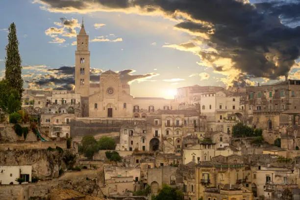 Matera, Basilicata, Italy. August 2021. The facade of the cathedral at the golden hour. Around the typical houses of the stones of Matera.