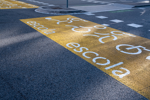 Road with school crossing sign indicates children crossing the street - Escola