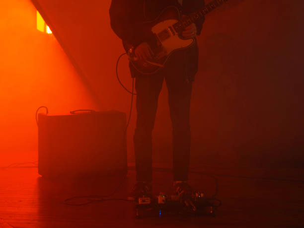istock Guitarist Standing With Instrument Playing Guitar 1385956997