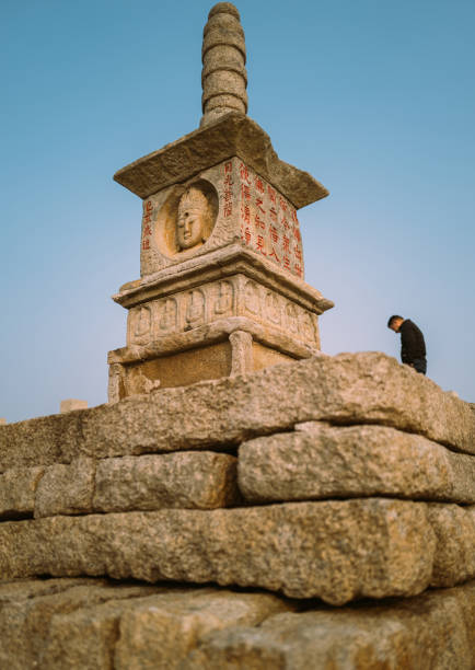 Quanzhou,Fujian Privince,China, February 28th 2022: A local man walking on Luoyang Bridge, which is the longest and oldest stone bridge in Quanzhou.A pagoda can be seen on the bridge.