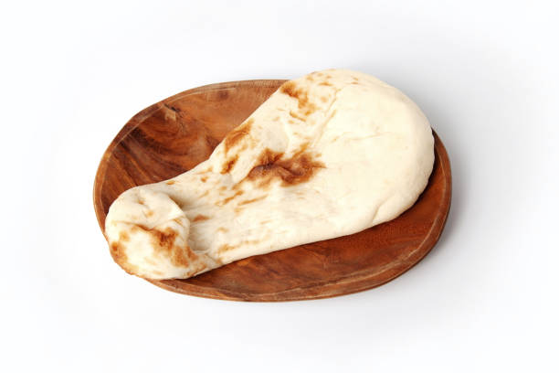 naan indian bread on plate isolated on white background