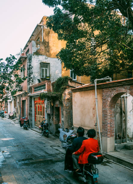 Quanzhou,Fujian Privince,China, February 28th 2022: locals riding scooter and enjoying sunshine, local landscape and daily life in Quanzhou, which is one of the oldest cities in China and considered as the start point of Silk Road on ocean.