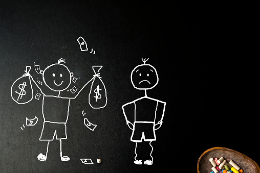Rich man and poor man, funny stickman with money coming out of his ears and another with empty pockets, concept of richness and poverty, freehand drawing on a blackboard and colored chalks.