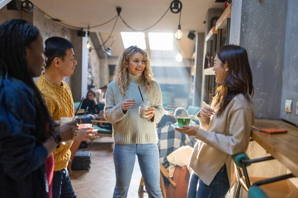 istock Multiracial group of friends enjoy casual conversation while drinking coffee 1385961431