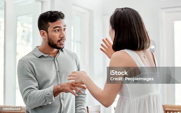 Shot Of A Young Couple Having An Argument At Home Stock Photo - Download Image Now - Arguing, Fighting, Wife