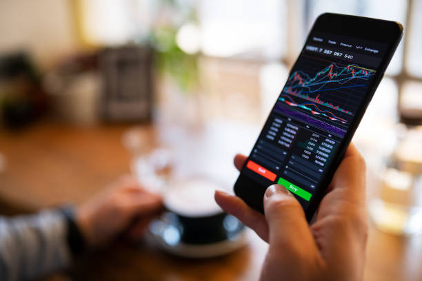 istock Trading with cryptocurrency on smartphone and enjoying coffee. 1385966729