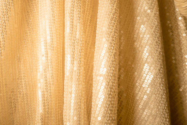istock Shinny golden fabric with rounded beadwork 1385967879