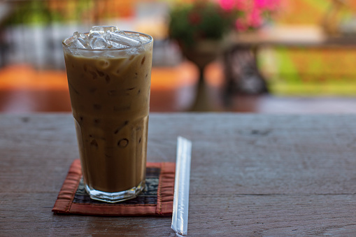 Iced milk coffee on table and blurred background