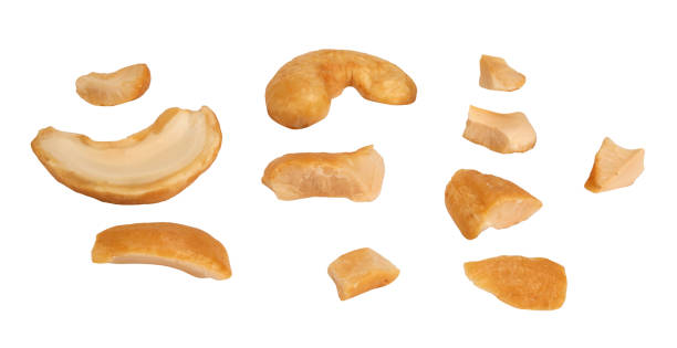 istock Cashew crushed into many pieces close-up isolated on white background 1385968942