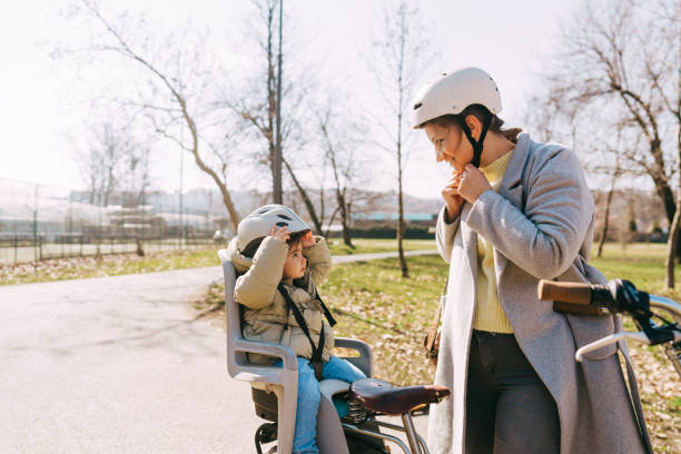 Commute to kindergarten with mom by bicycle stock photo