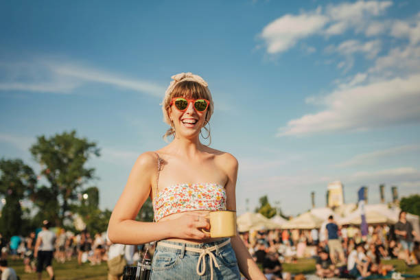 Summer vibes and sunshine above me Young woman enjoys a warm summer day. Festival lady. festival goer stock pictures, royalty-free photos & images