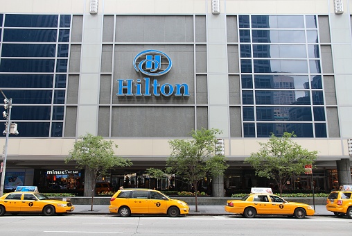 Taxi cabs parked by Hilton hotel in New York. Hilton is  the 38th largest private company in the United States according to Forbes.