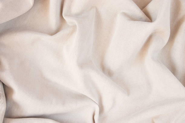 istock Light fabric texture. Background with folds. Close-up. 1385973617