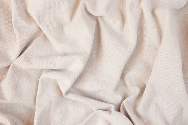 istock Light fabric texture. Background with folds. Close-up. 1385973649
