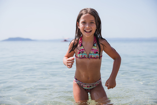 Cheerful young girl having a great time at the seaside