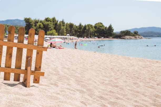 Wooden fence placed on the beach as an access sign