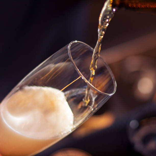 istock bartender pouring beer in to the glass 1385974182