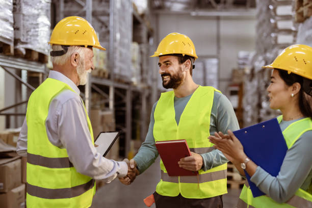 istock Senior Businessman having Handshake with Warehouse Worker 1385975657