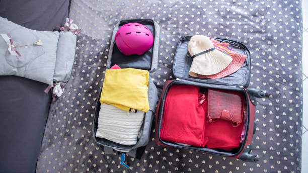 istock Packing for a trip.
Open  packed suitcase ready for vacation, top view 1385977261