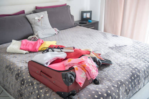 istock Packing the bags on the bed. 1385977343