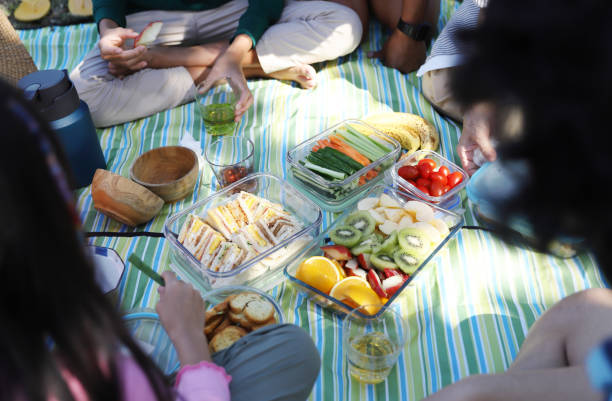 a Asian family having a picnic on the beach.