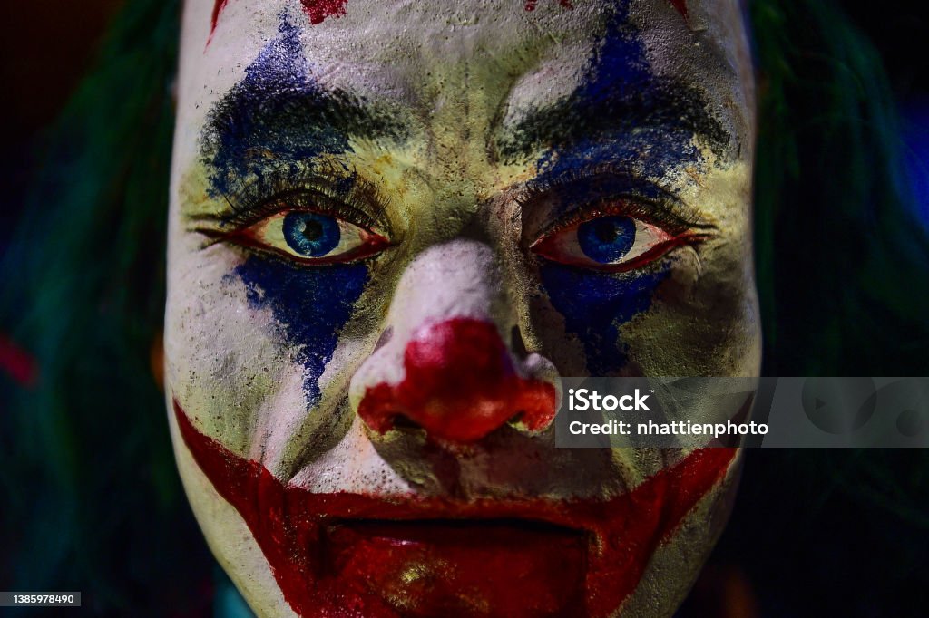 Creepy Evil Clown Mannequin Face Close Up Image High Resolution Against a dark background. Creepy Evil Clown Mannequin Face Close Up Image High Resolution Against a dark background. Costume. Joker. Horror Stock Photo
