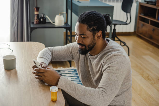 istock Young man is reading about a medicine on the internet 1385981570